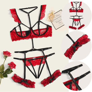 A red lace bodysuit lingerie with adjustable straps and a thong, displayed on a flat surface with a decorative item and a rose beside it.