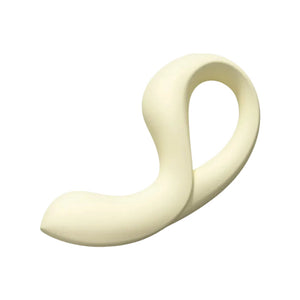 A minimalist, curved silicone personal massager in a warm cream or off-white color, shown against a solid off-white background.