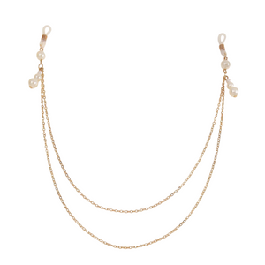 Gold chain eyeglass holder with pearl accents on a white background